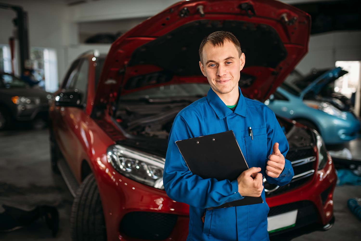 technician-with-notebook-car-with-opened-hood-small.jpg